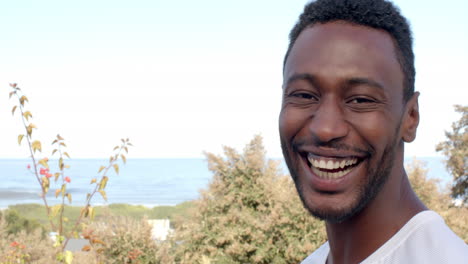 african american man smiling joyfully outdoors, copy space
