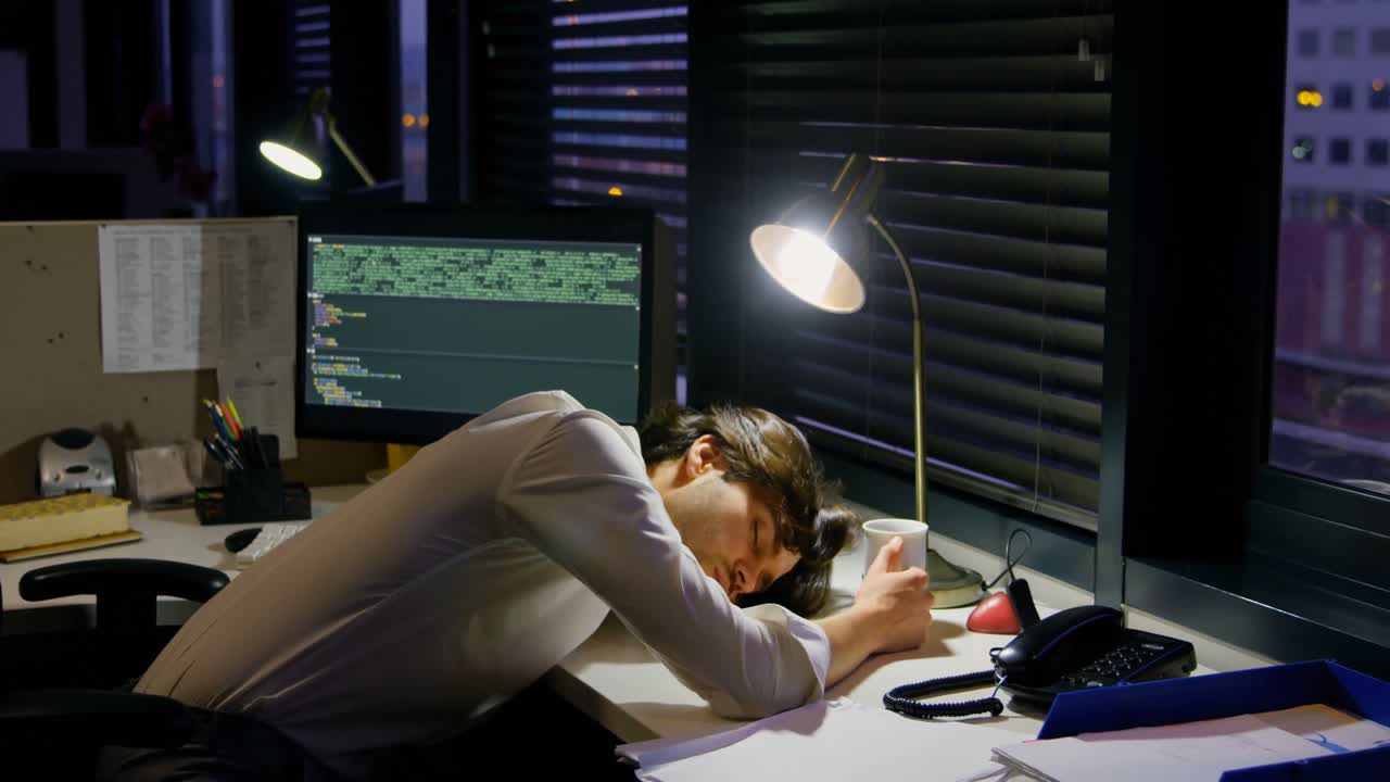 Male executive sleeping on desk 4k