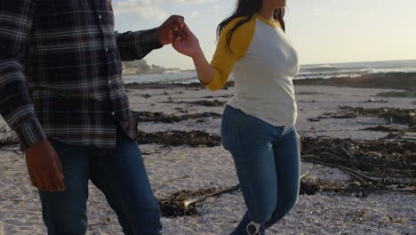 couple walking with hand in hand at beach on sunny day 4k