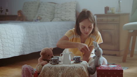 a girl playing with dolls in her room
