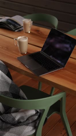 cozy outdoor workspace with laptop and coffee