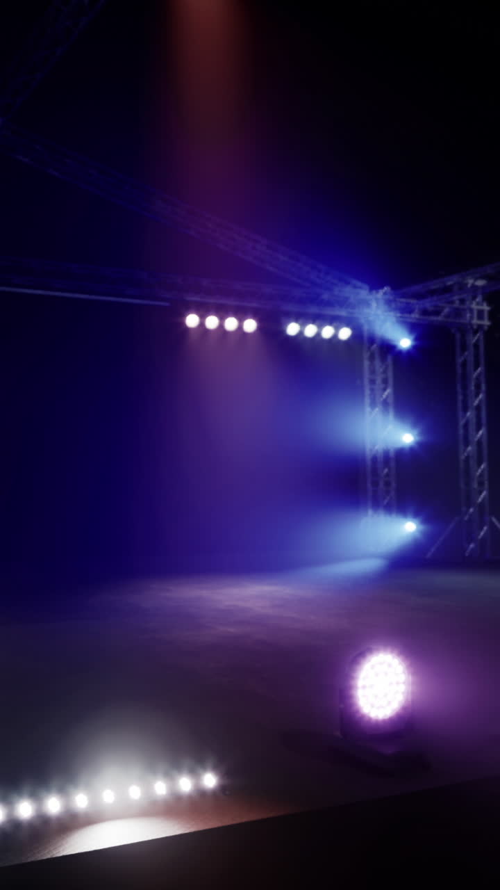 Spotlights shine on a stage at night for a live performance event