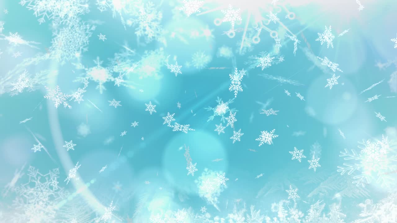 クリスマスの青い背景に光の点が輝く中、雪が降るアニメーション