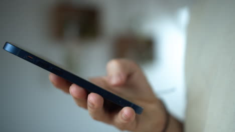 a man holding his smartphone and texting in an isolated white background