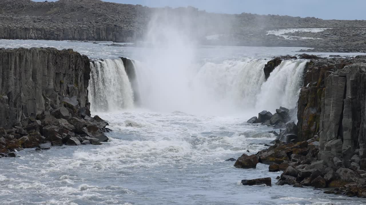 Aerial view of crashing godafoss waterfall on Iceland island. Rocky basalt hills of volcanic landscape. Famous destination for tourism