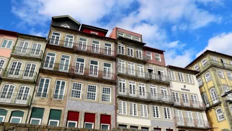 establisher panning shot of colorful facades of porto located in cais da ribeira