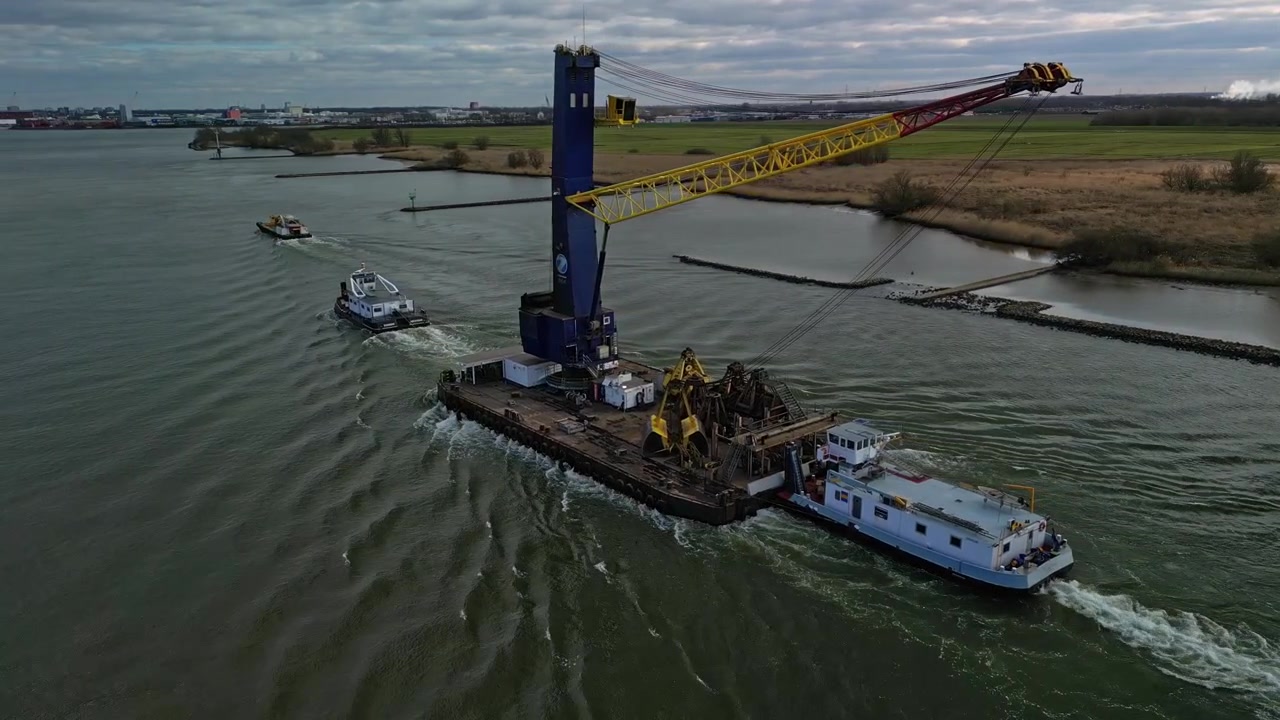 Aerial View Of Tug Boats Helping Floating Crane Along Oude Maas In Zwijndrecht