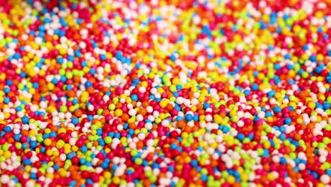 hand interacting with colorful candy sprinkles