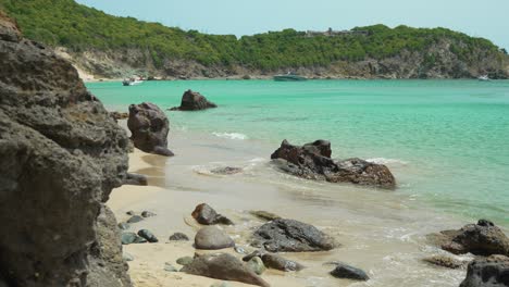 static shot of colombier beach with continuous waves at shoreline in saint barthelemy island