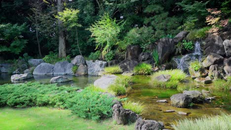 a small waterfall in a garden of a buddhist temple in japan