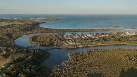 aerial view of a coastal town with river and ocean