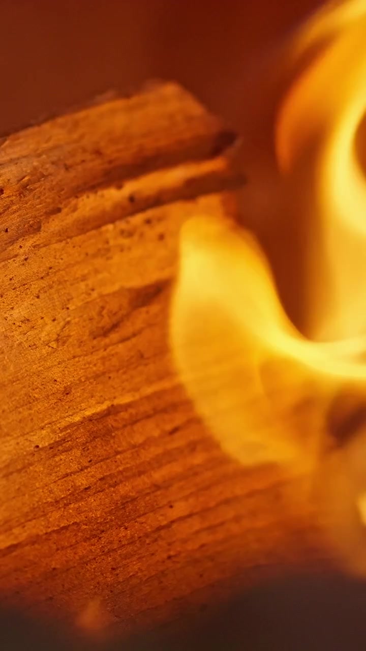 Close-up of Golden Flames Burning on Wood