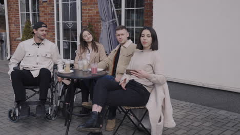 group of friends taking a selfie in a bar terrace