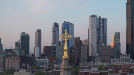 aerial view of a crucifix on a church steeple in brooklyn. shot on a spring day.