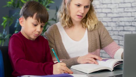 handheld video of mom with her son doing homework