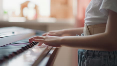 young person plays smooth melody on electronic piano