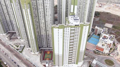 Aerial-shot-of-Downtown-Hong-Kong-mega-residential-skyscrapers-and-traffic,-on-a-beautiful-day