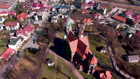 aerial shot of huge old church located in the small town