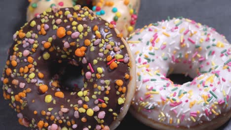 sweet donuts spinning on a dark background. traditional american sweetness