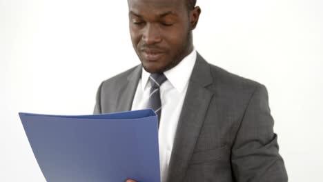 Portrait-of-businessman-smiling-and-holding-a-file