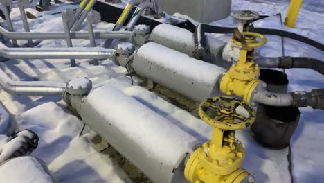 panning shot of fuel bulk plant showcasing piping and large wheel valves