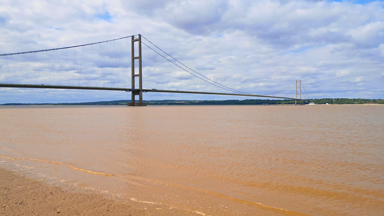 A drone video shows Humber Bridge, 12th largest suspension span, crossing River Humber, linking Lincolnshire to Humberside amid traffic