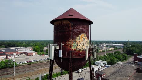 circular drone flight around the old grafitti-painted warwick water tower