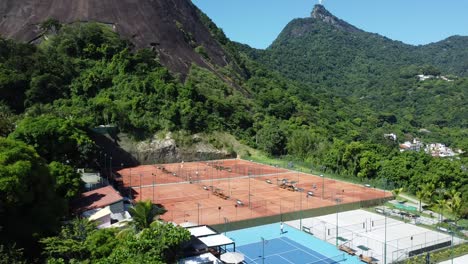 tennis courts in the middle of city and natuire