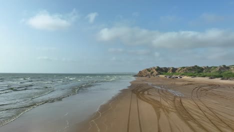 Panoramic-aerial-view-of-Gadani-beach-landscape,-People-gathered-at-Gadani-beach-for-a-drifting-race-alongside-the-Arabian-Sea,-Balochistan,-Pakistan