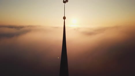 aerial drone view through clouds on church in old town riga, latvia, europe