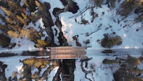 top down view of bridge and river in winter