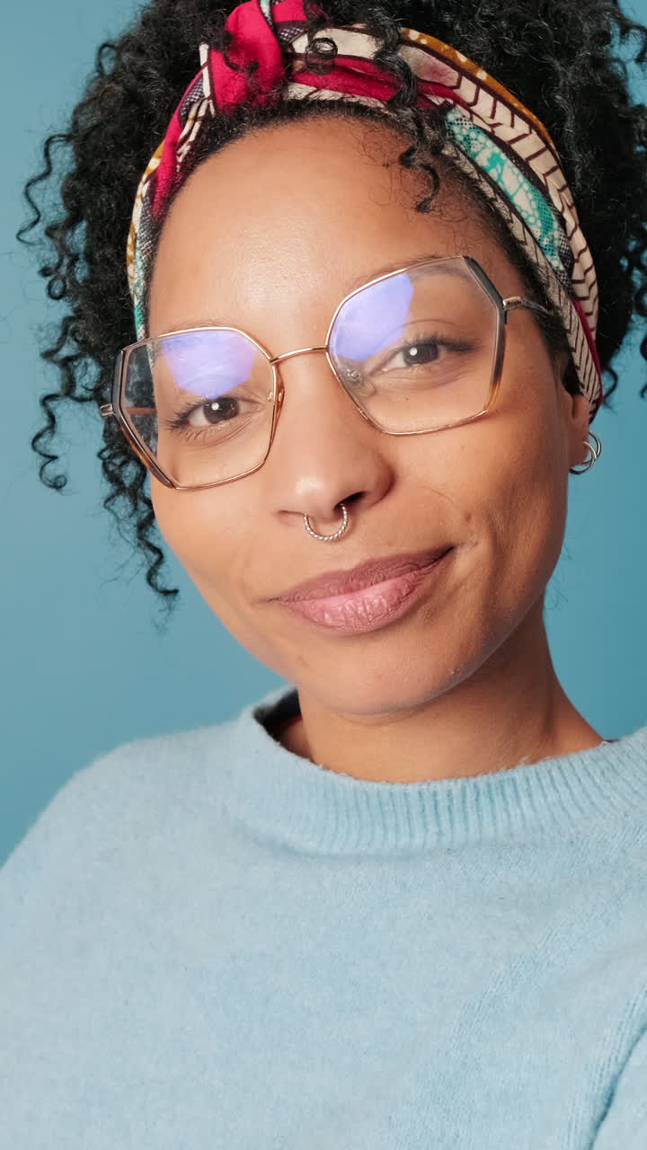 Young Woman with Curly Hair Smiling and Making Peace Sign