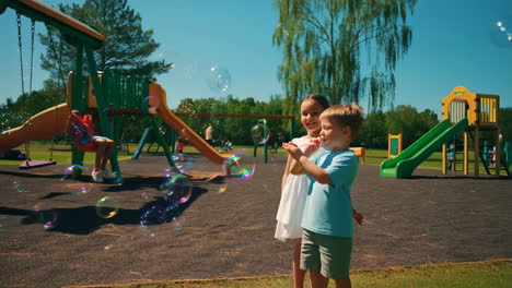 children blowing bubbles at a playground