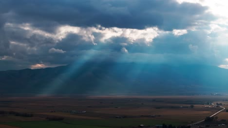 cinematic drone shot of sunlight rays through storm clouds