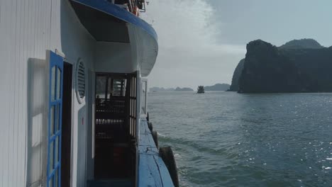 pov view along wooden ferry boat sailing through lan ha bay