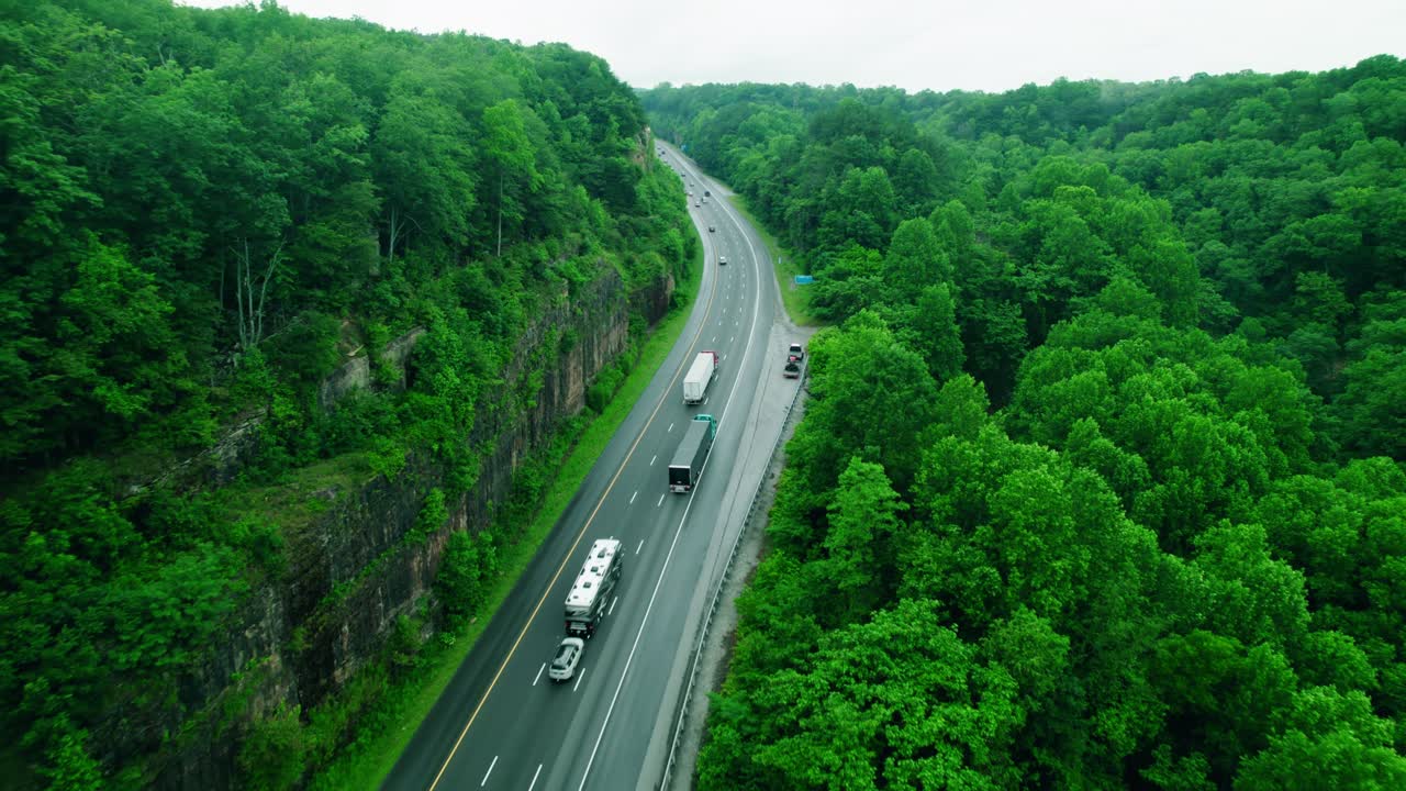 Semi trucks transporting cargo along I-24 through Monteagle, Tennessee, heavy-duty logistics operations and supply chain.