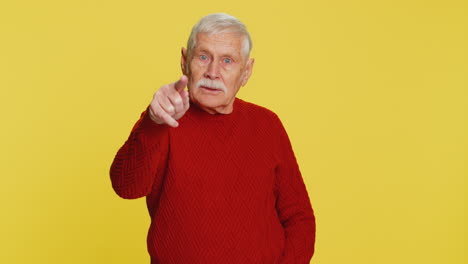 happy senior smiling man pointing finger to camera making winner choice showing direction select