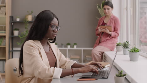 two women working in a modern office
