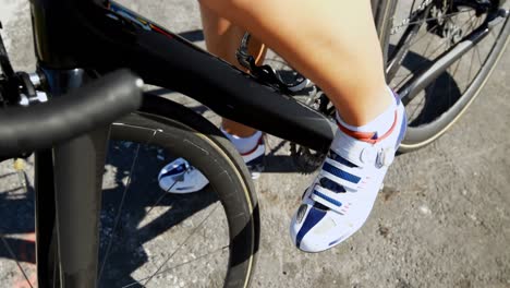 female cyclist cycling on a countryside road 4k