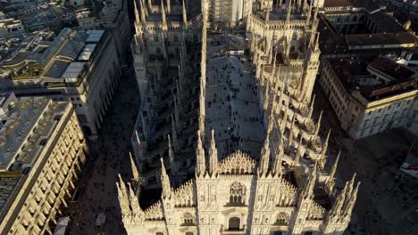 aerial top down view of duomo of milan with tourist gathering on the roof of the ancient historical church