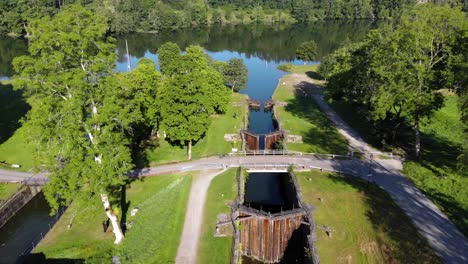 inoperative aged staircase lock in sweden surrounded by green forest, aerial