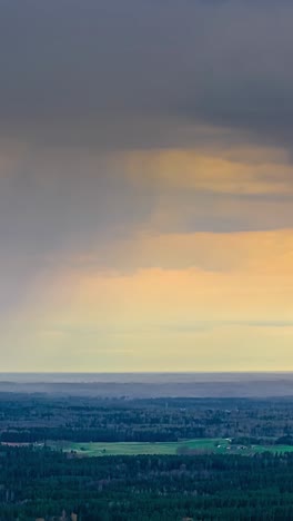 dark rain clouds swiftly move across the landscape in a dramatic time-lapse scene