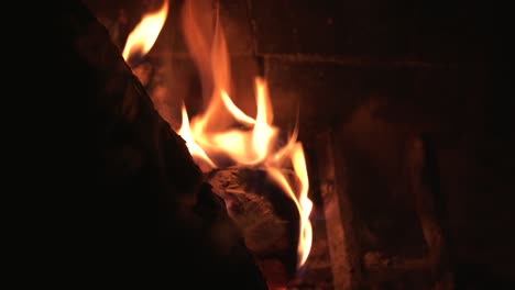 Close-Up-Flames-Dancing-in-Front-of-Brick-Background