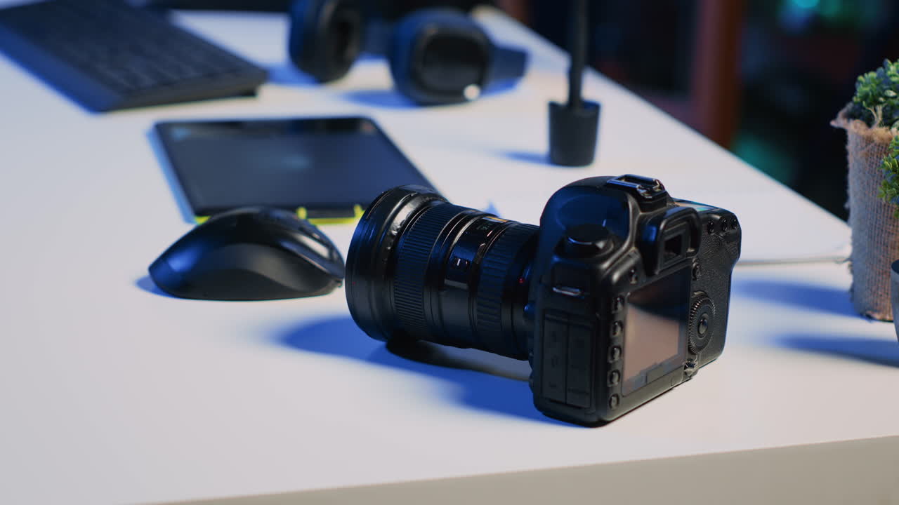 Professional camera equipment in empty blue neon lit creative photography studio