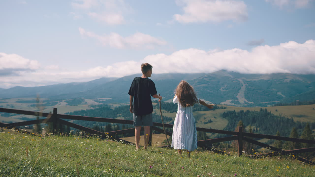 Siblings Enjoying a Scenic Mountain View