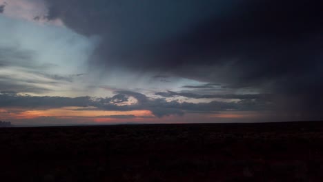 slow panning shot of a desert sunset with thunderstorm approaching