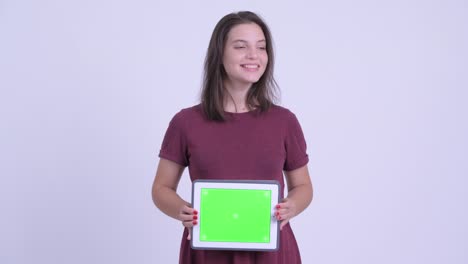 happy young beautiful pregnant woman with digital tablet