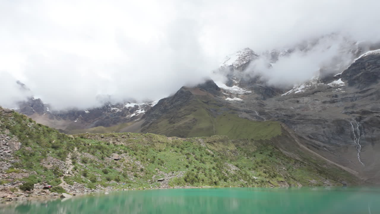 Turquoise Humantay Lake with snow-capped Humantay and Salkantay peaks in slow motion