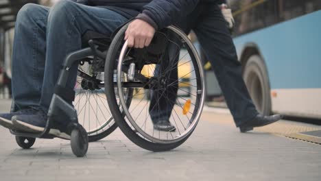 person with a physical disability leaves public transport with an accessible ramp