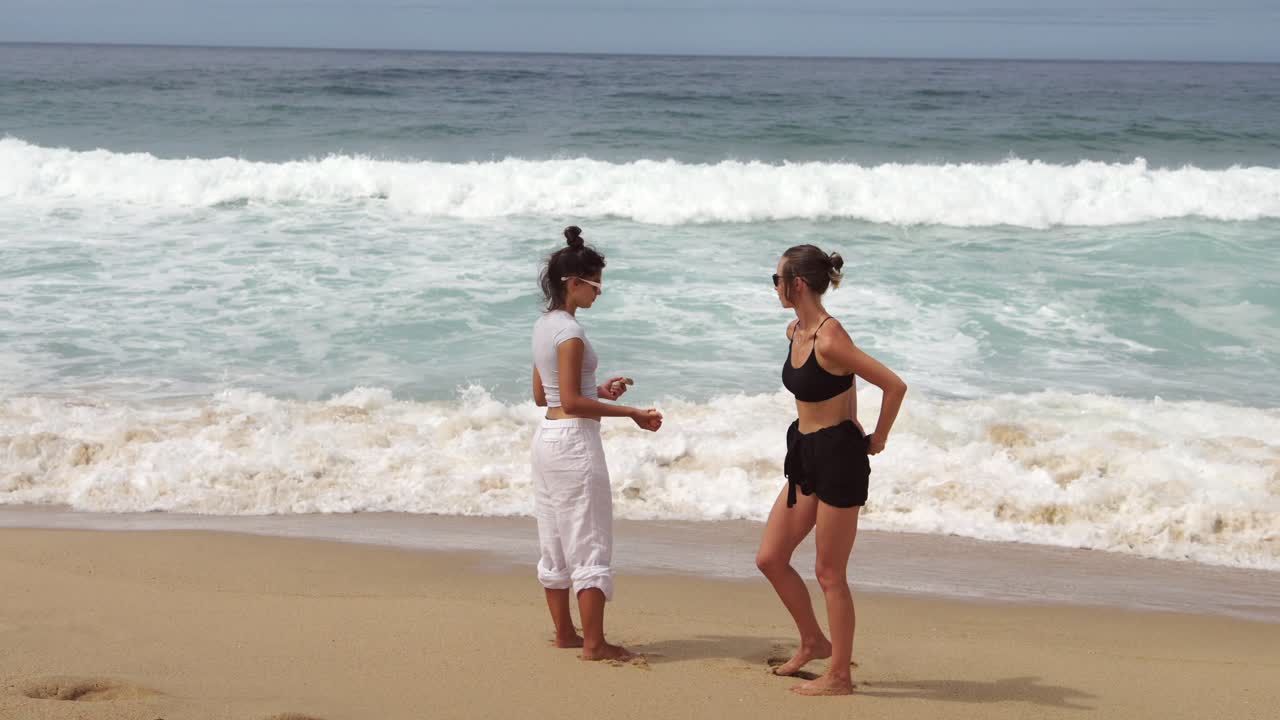Two women on a beach with waves